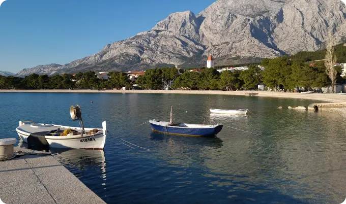 Three boats docked on the sea near beach